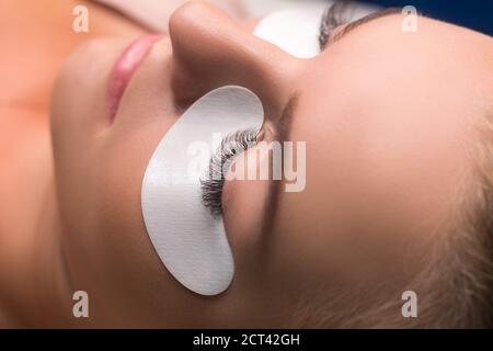 Woman with long lashes in a beauty salon. Eyelash extension Stock Photo