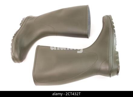 Pair of clean green rubber boots laying down isolated on white background. Front view. Stock Photo