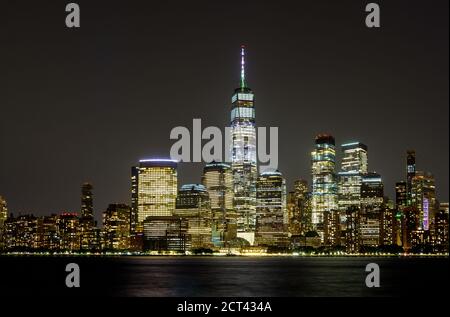 New York City Manhattan NY skyline panorama at night over Hudson river with reflections viewed from New Jersey USA Stock Photo