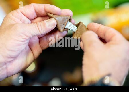 Hameln, Germany. 10th Sep, 2020. Michael Rohrdrommel, founder and managing director of Happy Glückskeks, opens a fortune cookie in the company's warehouse. Since 2018 the start-up from Hameln has been developing and producing its own fortune cookies with inspiring messages. (to dpa 'Lower Saxony wants to sell one million fortune cookies a year' from 21.09.2020) Credit: Hauke-Christian Dittrich/dpa/Alamy Live News Stock Photo