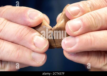 Hameln, Germany. 10th Sep, 2020. Michael Rohrdrommel, founder and managing director of Happy Glückskeks, opens a fortune cookie in the company's warehouse. Since 2018 the start-up from Hameln has been developing and producing its own fortune cookies with inspiring messages. (to dpa 'Lower Saxony wants to sell one million fortune cookies a year' from 21.09.2020) Credit: Hauke-Christian Dittrich/dpa/Alamy Live News Stock Photo