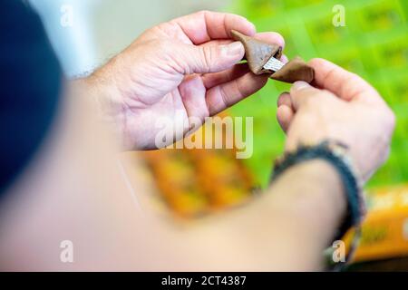 Hameln, Germany. 10th Sep, 2020. Michael Rohrdrommel, founder and managing director of Happy Glückskeks, opens a fortune cookie in the company's warehouse. Since 2018 the start-up from Hameln has been developing and producing its own fortune cookies with inspiring messages. (to dpa 'Lower Saxony wants to sell one million fortune cookies a year' from 21.09.2020) Credit: Hauke-Christian Dittrich/dpa/Alamy Live News Stock Photo