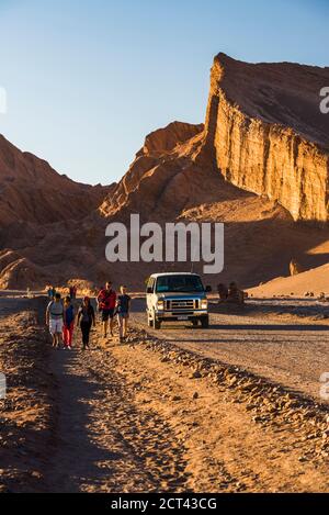 Driving past the Amphitheatre rock formation in Moon Valley (Valle de la Luna), Atacama Desert, North Chile, South America Stock Photo