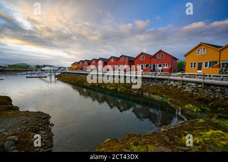 Beautiful waterfront house reflecting the water Evening and twilight sky at ballstad city, lofoten island in northern Norway. Rorbuer is the tradition Stock Photo