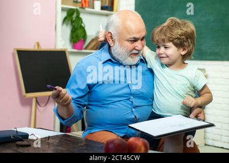Elementary school and education. Concept of a retirement age. Father and son. World teachers day. Teacher is skilled leader. Family generation and Stock Photo