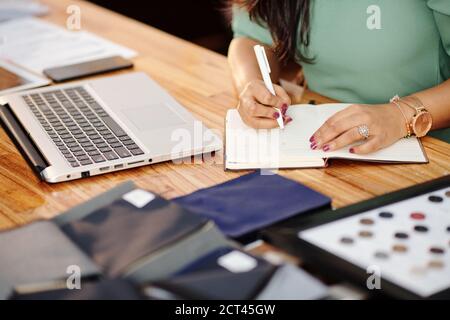 Aatelier owner writing in planner Stock Photo