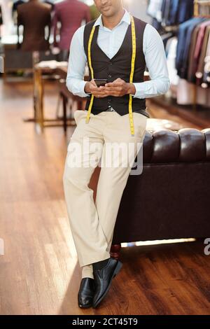 Atelier owner checking text messages Stock Photo
