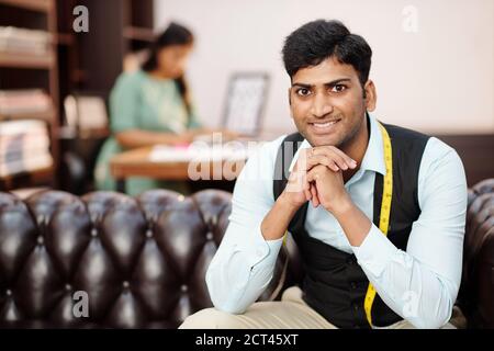 Handsome young Indian tailor Stock Photo