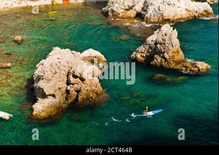 Sea Kayaking in Dubrovnik, a tourist kayaking in the Mediterranean Sea, Croatia Stock Photo