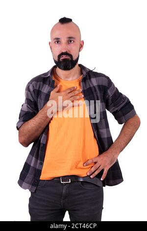 Worried young hispanic man with his hand on his chest Stock Photo