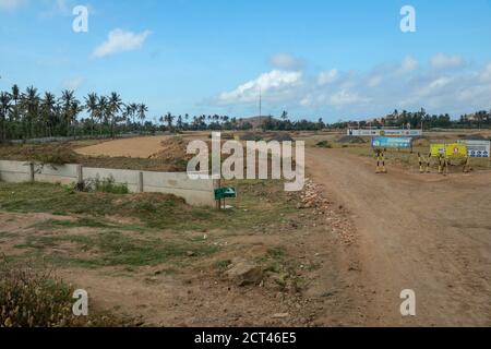 Construction of a complex on the Motogp Mandalika circuit, West Nusa Tenggara, Lombok, Indonesia. Banners with a plan of the area and the racing Stock Photo