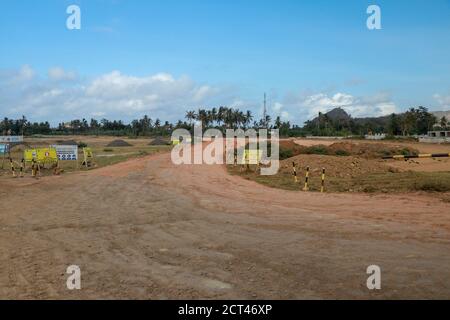 Construction of a complex on the Motogp Mandalika circuit, West Nusa Tenggara, Lombok, Indonesia. Banners with a plan of the area and the racing Stock Photo