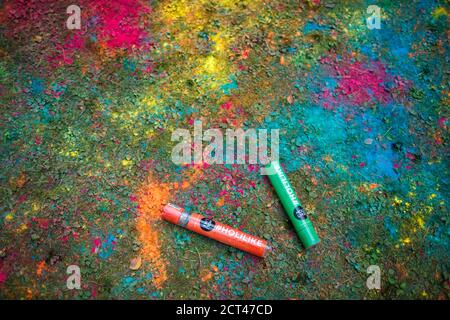 Full frame shot of painted ground and two holi powder shooter. Stock Photo