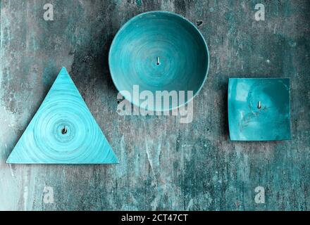 Decorative plates of various shapes on old grunge textured wall Stock Photo