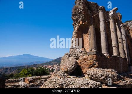 Taormina Greek Theatre aka Teatro Greco, ruins of columns at the amphitheatre, with Mount Etna Volcano in the background, Sicily, Italy, Europe Stock Photo