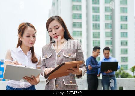 Entrepreneur showing tablet to assistant Stock Photo