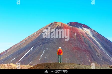 Man walking on hike trail route with New Zealand volcano,  Tramping, hiking, travel in New Zealand. Stock Photo