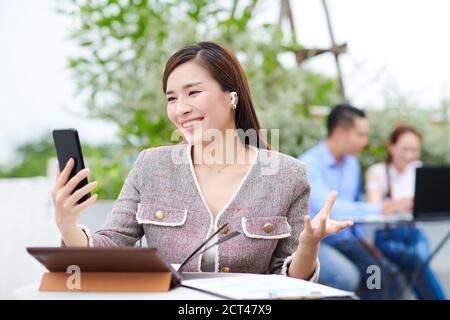 Video calling female entrepreneur Stock Photo