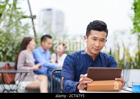 Businessman watching presentation on tablet Stock Photo