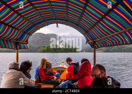 Traditional Pletna rowing boat ride to Lake Bled Island and the Church of Assumption, Bled, Gorenjska, Slovenia, Europe Stock Photo