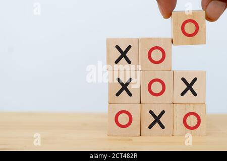 tic tac toe concept. leader business man try flip wooden cube to speed win the game of  OX for fast winning  by using strategy to make opportunity suc Stock Photo