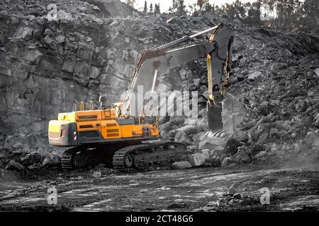 Excavator work loading of coal into Yellow mining truck. Open pit mine ...