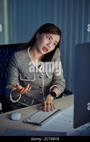 UI designer working in dark office Stock Photo