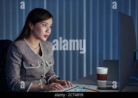 Businesswoman working at night Stock Photo
