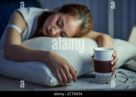 Office worker fell asleep at desk Stock Photo
