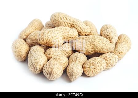 Bunch of whole roasted peanut shells on white background Stock Photo