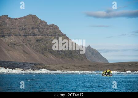 Zodiac boat tour of Jokulsarlon Glacier Lagoon, a glacial lake filled with icebergs in South East Iceland, Europe Stock Photo