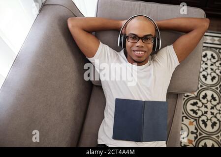 Black man relaxing on sofa Stock Photo