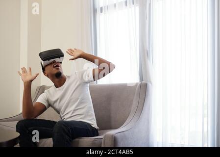 Scared man in VR headset Stock Photo
