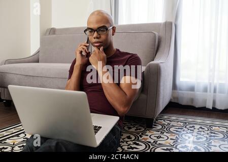 Freelancer talking on phone with client Stock Photo
