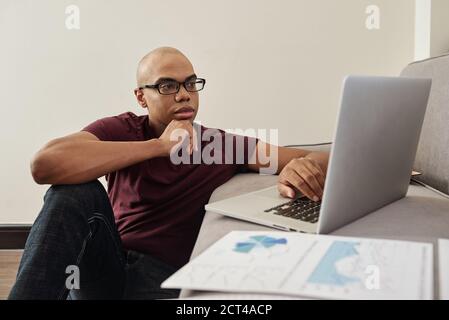 Pensive entrepreneur working from home Stock Photo