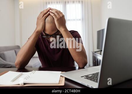 Stressed man at desk Stock Photo