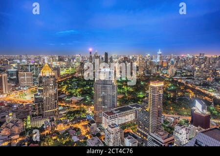 Bangkok Thailand, night city skyline of skyscraper at Bangkok downtown and Lumpini Park