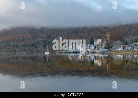 Kenmore town reflected in the Loch Tay Lake with autumn trees reflections, Perthshire, Highlands of Scotland, United Kingdom, Europe Stock Photo