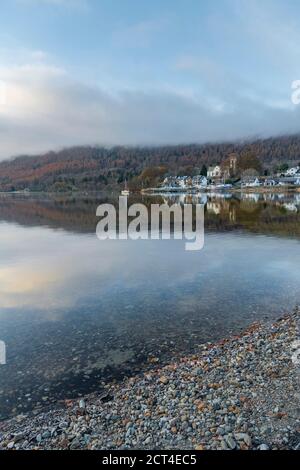 Kenmore town reflected in the Loch Tay Lake with autumn trees reflections, Perthshire, Highlands of Scotland, United Kingdom, Europe Stock Photo