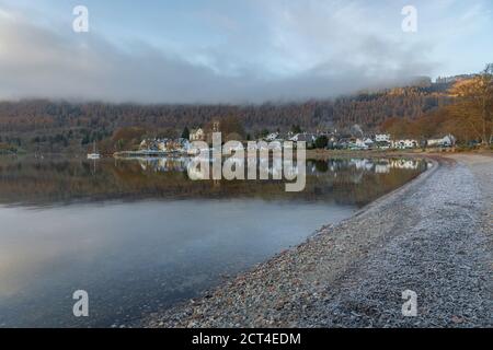 Kenmore town reflected in the Loch Tay Lake with autumn trees reflections, Perthshire, Highlands of Scotland, United Kingdom, Europe Stock Photo