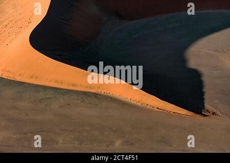 Contrasted abstract of the Oxide rich red sand dunes in the great sand sea of Namibia. Stock Photo