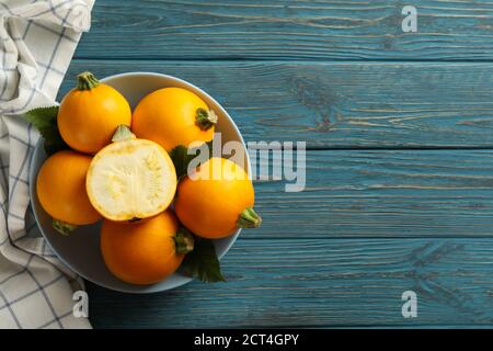 Bowl with round zucchini and napkin on wooden table Stock Photo