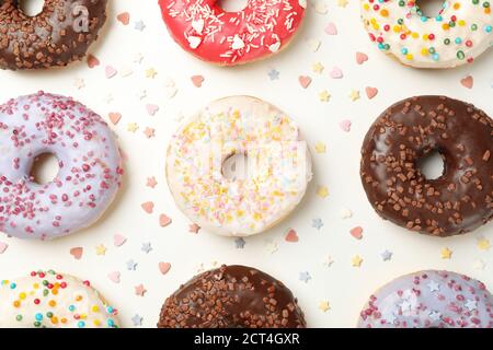 Flat lay with tasty donuts on white background Stock Photo
