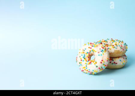 Tasty donuts on two tone background, space for text Stock Photo