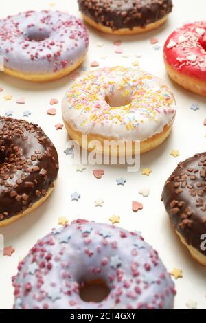 Flat lay with tasty donuts on white background Stock Photo