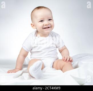 Photo of sitting eleven-month-old baby on a white background Stock Photo