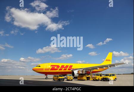 Schkeuditz, Germany. 29th July, 2020. A DHL cargo aircraft and various vehicles for logistics are on the apron at Leipzig/Halle Airport. The freight business at Leipzig Airport is growing steadily even in Corona times. Credit: Jan Woitas/dpa-Zentralbild/dpa/Alamy Live News Stock Photo