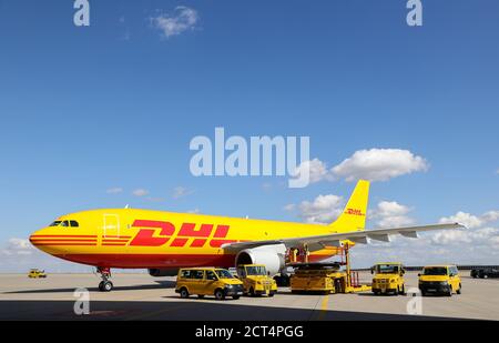 Schkeuditz, Germany. 29th July, 2020. A DHL cargo aircraft and various vehicles for logistics are on the apron at Leipzig/Halle Airport. The freight business at Leipzig Airport is growing steadily even in Corona times. Credit: Jan Woitas/dpa-Zentralbild/dpa/Alamy Live News Stock Photo