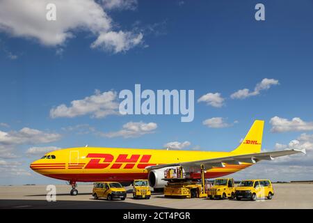 Schkeuditz, Germany. 29th July, 2020. A DHL cargo aircraft and various vehicles for logistics are on the apron at Leipzig/Halle Airport. The freight business at Leipzig Airport is growing steadily even in Corona times. Credit: Jan Woitas/dpa-Zentralbild/dpa/Alamy Live News Stock Photo