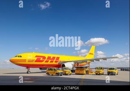 Schkeuditz, Germany. 29th July, 2020. A DHL cargo aircraft and various vehicles for logistics are on the apron at Leipzig/Halle Airport. The freight business at Leipzig Airport is growing steadily even in Corona times. Credit: Jan Woitas/dpa-Zentralbild/dpa/Alamy Live News Stock Photo